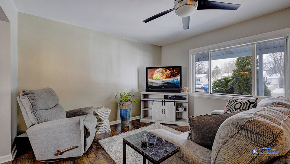 348 Raupp Boulevard Buffalo Grove, IL 60089 - Photo 2 of 41 a living room with furniture a large window and a flat screen tv