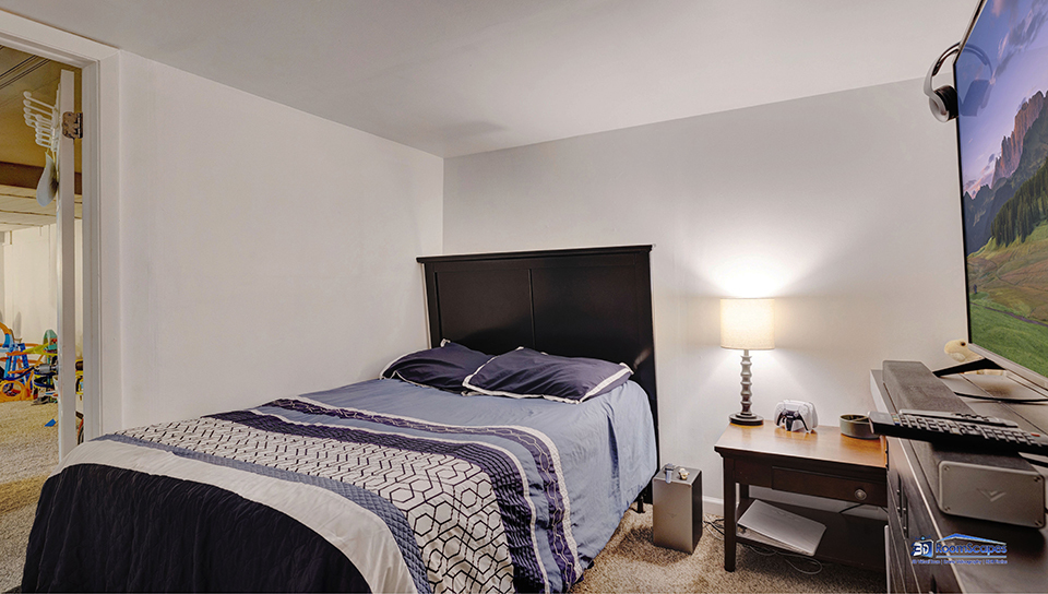 348 Raupp Boulevard Buffalo Grove, IL 60089 - Photo 23 of 41 a bedroom with a bed and a flat screen tv