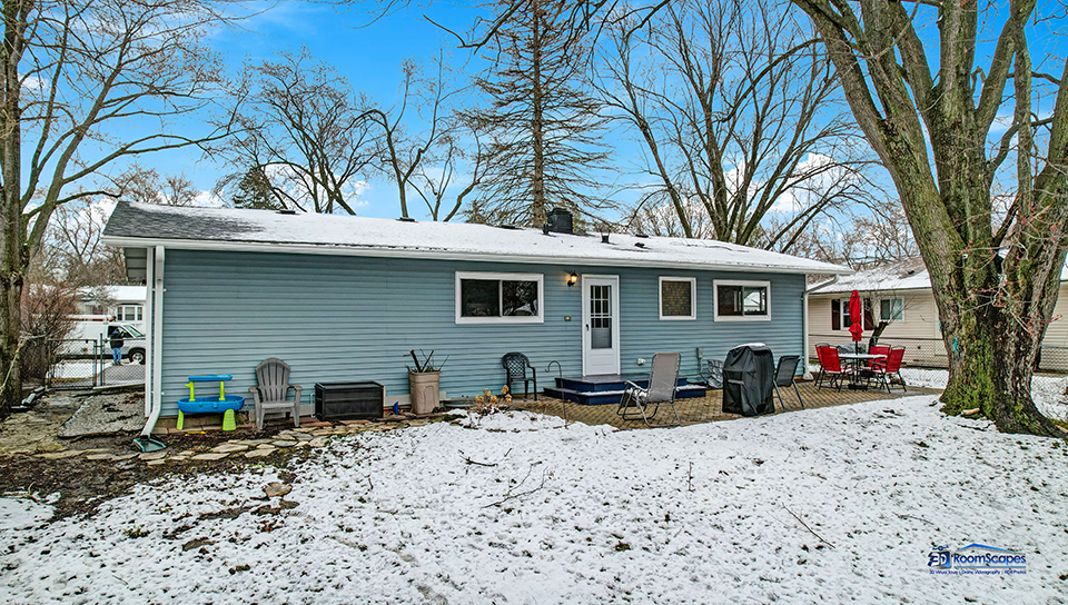 348 Raupp Boulevard Buffalo Grove, IL 60089 - Photo 33 of 41 a view of a house with a yard covered in snow