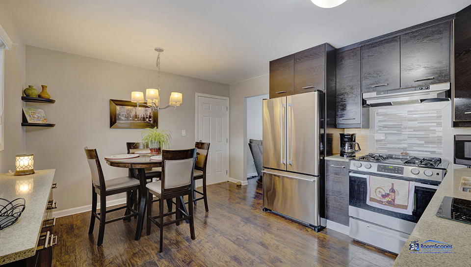 348 Raupp Boulevard Buffalo Grove, IL 60089 - Photo 7 of 41 a kitchen with stainless steel appliances a refrigerator a stove a dining table and chairs with wooden floor