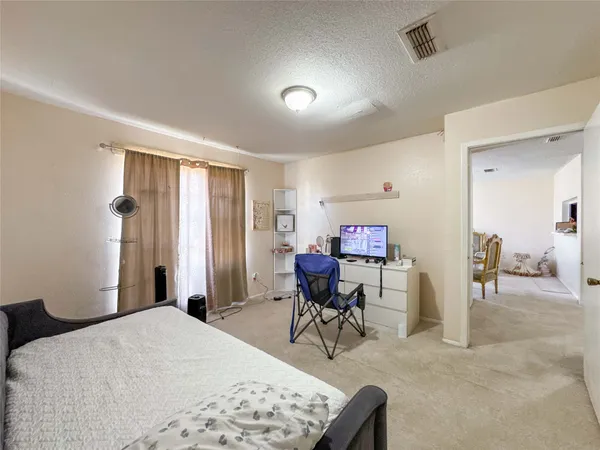 a spacious bedroom with a bed and a window