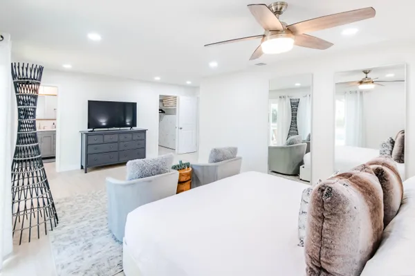 a large bedroom with a bed and furniture