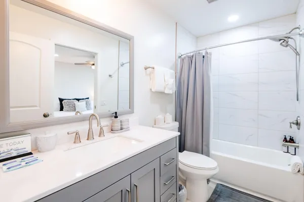 a bathroom with a sink toilet tub and shower
