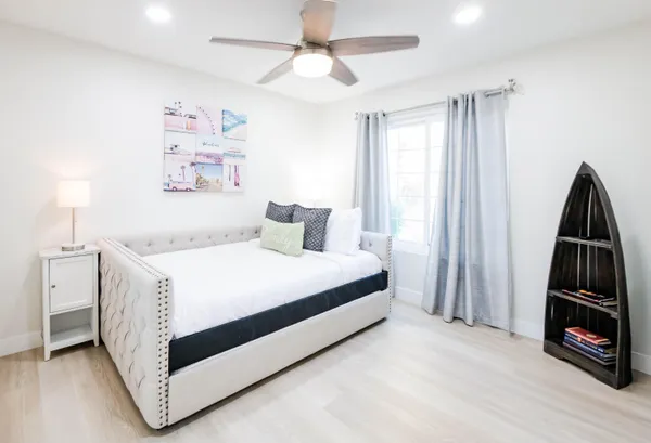 a bedroom with a bed and a tv