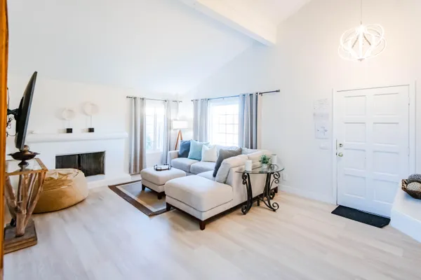 a living room with furniture and a fireplace