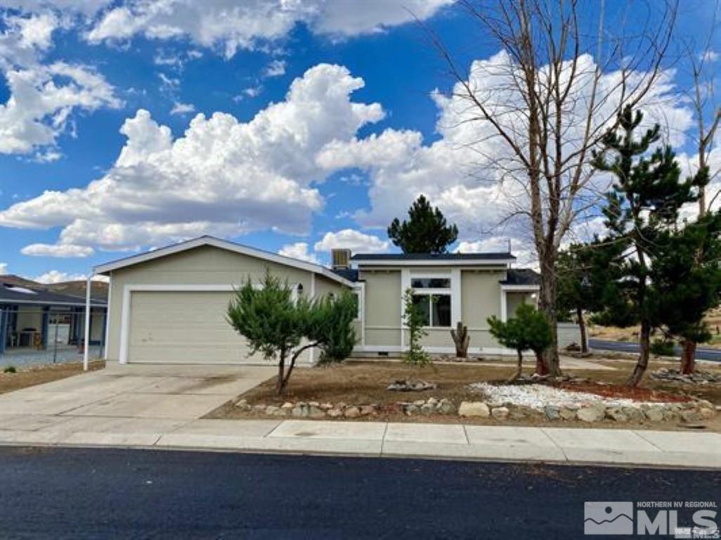 1397 Lynx Street Reno, NV 89506 - Photo 1 of 2 a front view of a house with garden and trees