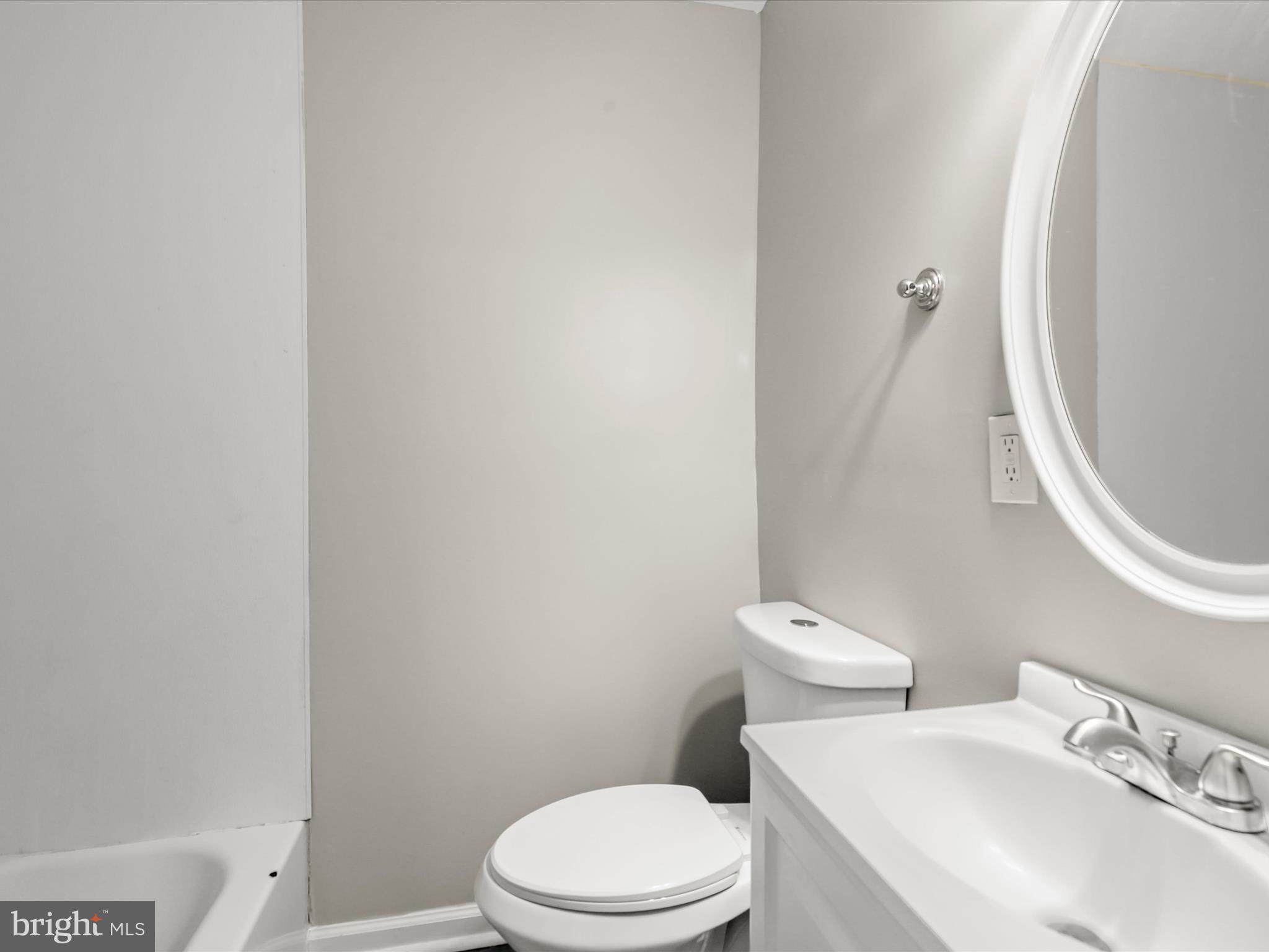 8351 Edgedale Road Baltimore, MD 21234 - Photo 12 of 22 a white toilet sitting next to a bathroom sink