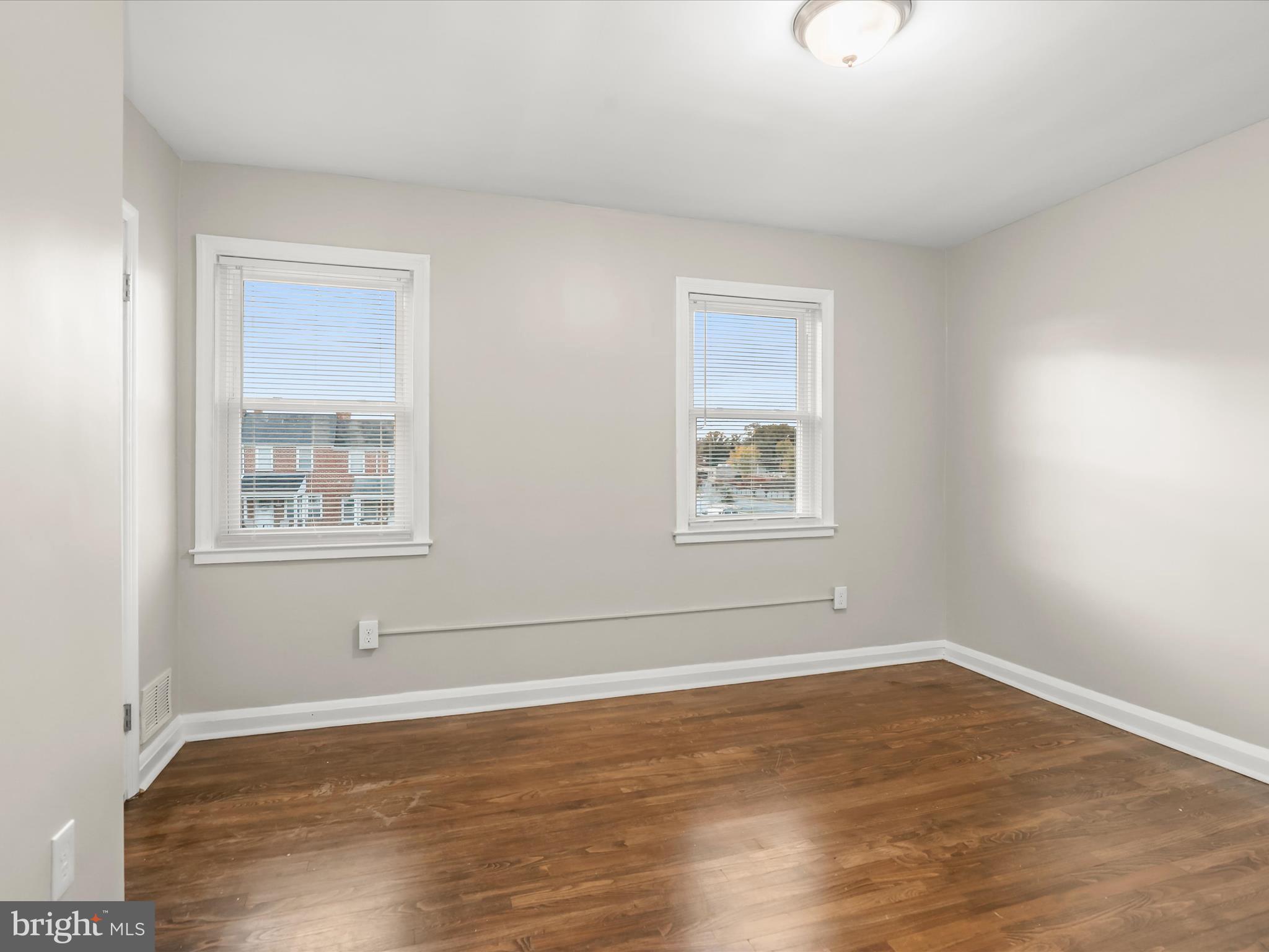 8351 Edgedale Road Baltimore, MD 21234 - Photo 13 of 22 a view of an empty room with wooden floor and a window