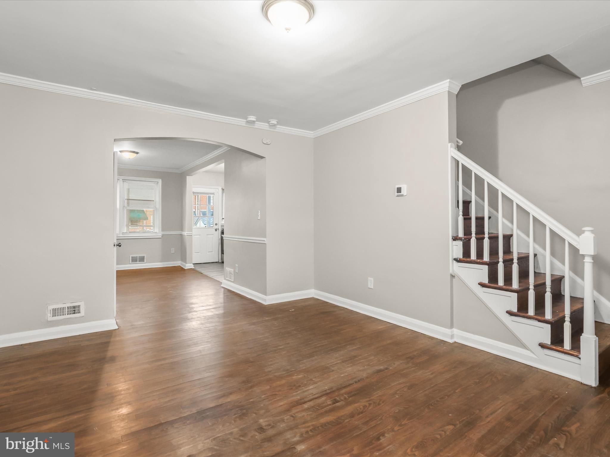 8351 Edgedale Road Baltimore, MD 21234 - Photo 7 of 22 a view of an empty room with wooden floor and a window