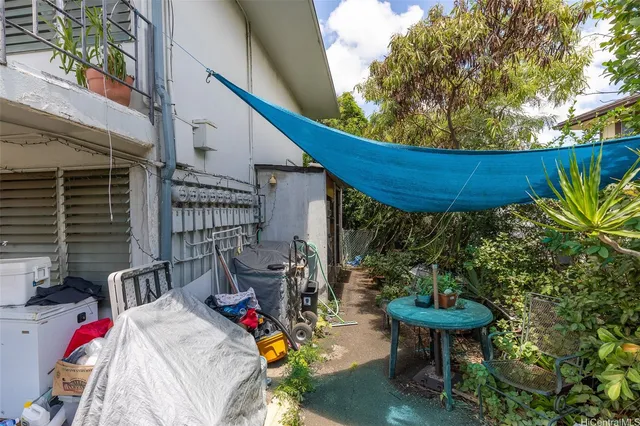 a view of roof deck with table and chairs barbeque with wooden fence