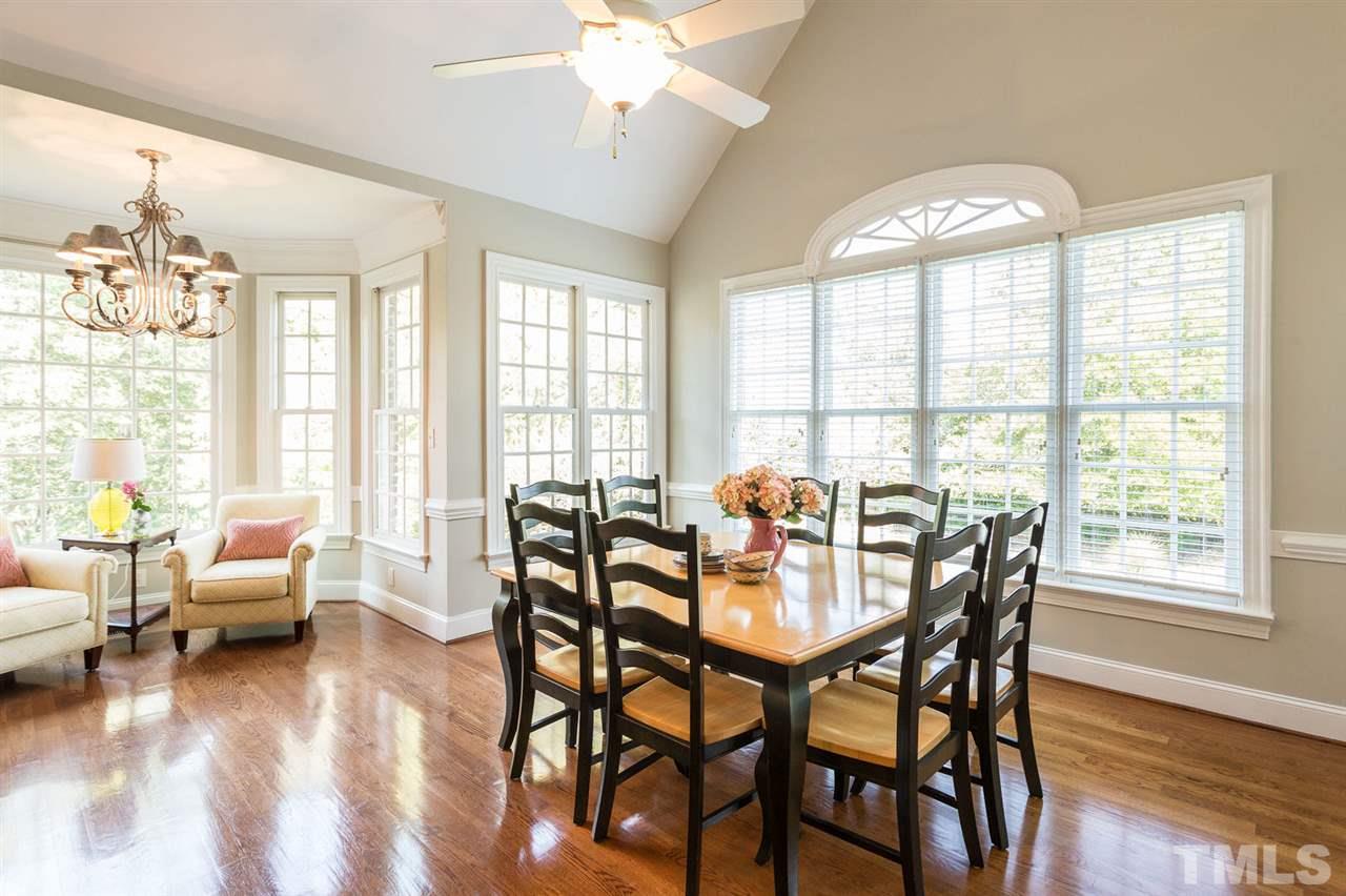12404 Bayleaf Church Road Raleigh, NC 27614 - Photo 12 of 25 a view of a dining room with furniture window and wooden floor