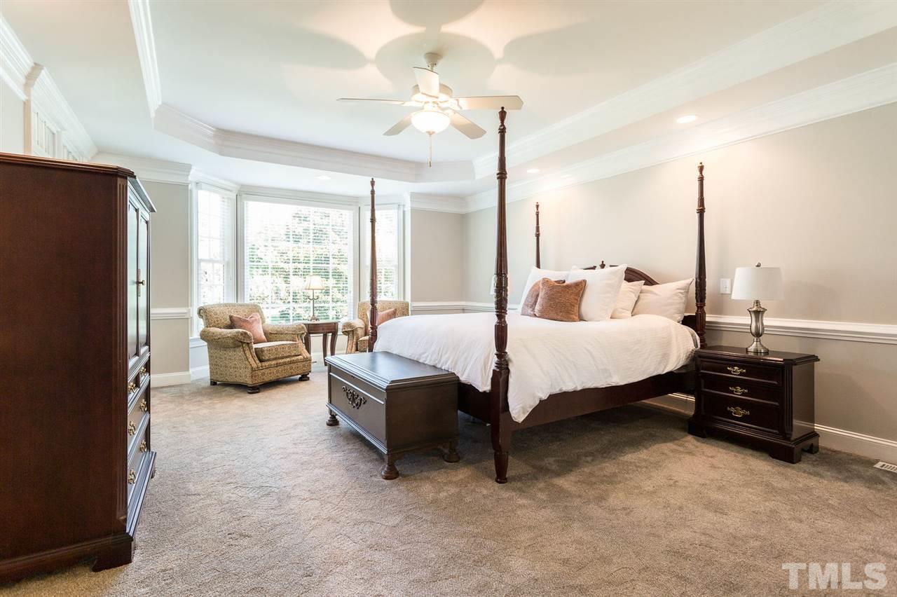 12404 Bayleaf Church Road Raleigh, NC 27614 - Photo 14 of 25 a spacious bedroom with a bed couch and a large window