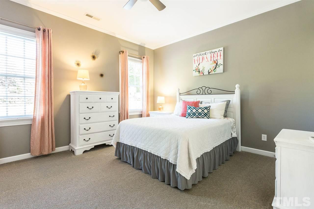 12404 Bayleaf Church Road Raleigh, NC 27614 - Photo 22 of 25 a bedroom with a bed and a dresser