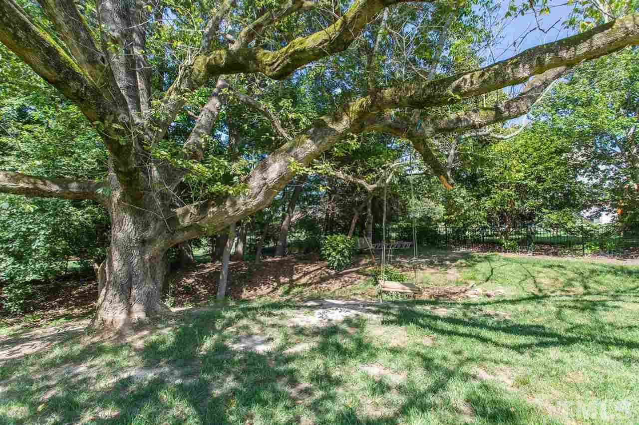 12404 Bayleaf Church Road Raleigh, NC 27614 - Photo 24 of 25 a backyard of a house with lots of green space