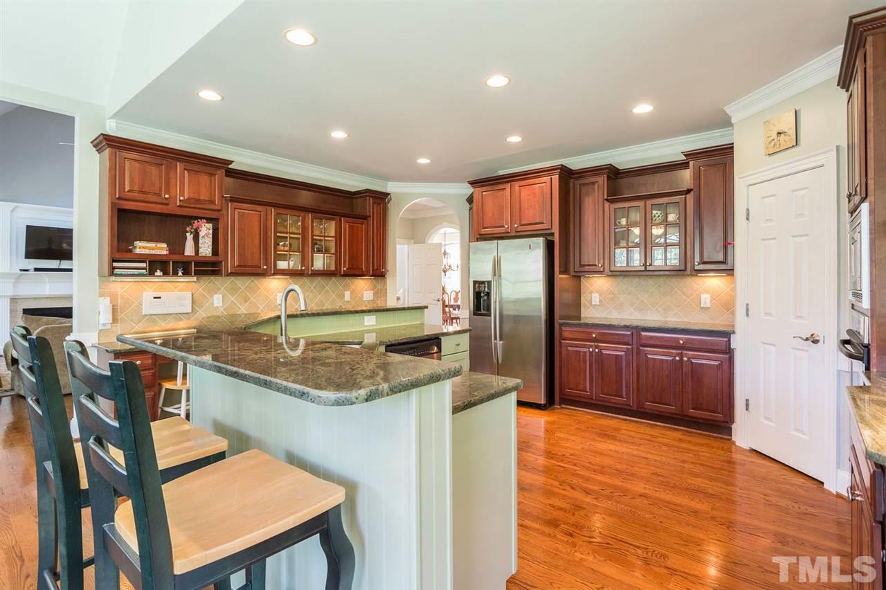 12404 Bayleaf Church Road Raleigh, NC 27614 - Photo 10 of 25 a kitchen with stainless steel appliances granite countertop a stove a sink and a refrigerator
