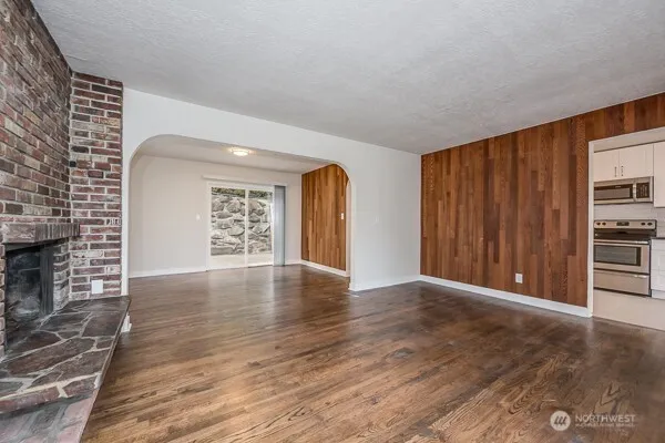 a kitchen with stainless steel appliances granite countertop a refrigerator a stove a sink and a microwave