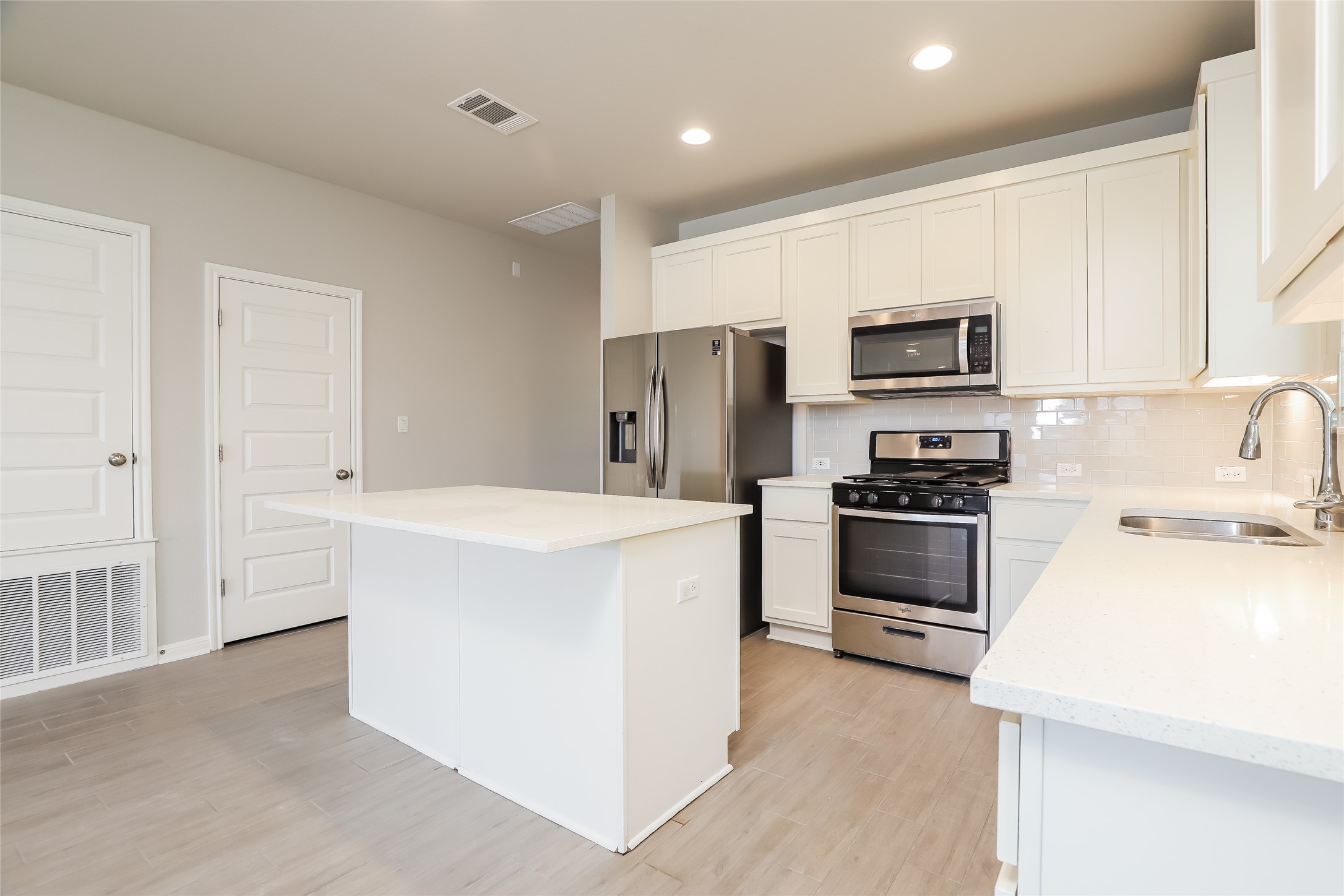 2724 Juniper Woods Road Leander, TX 78641 - Photo 5 of 21 A pristine kitchen features sleek stainless steel appliances, abundant cabinet space, and a functional center island.