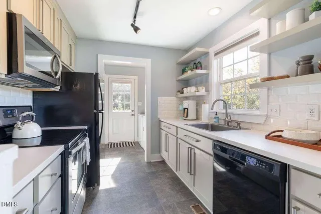 a kitchen with a sink cabinets and window