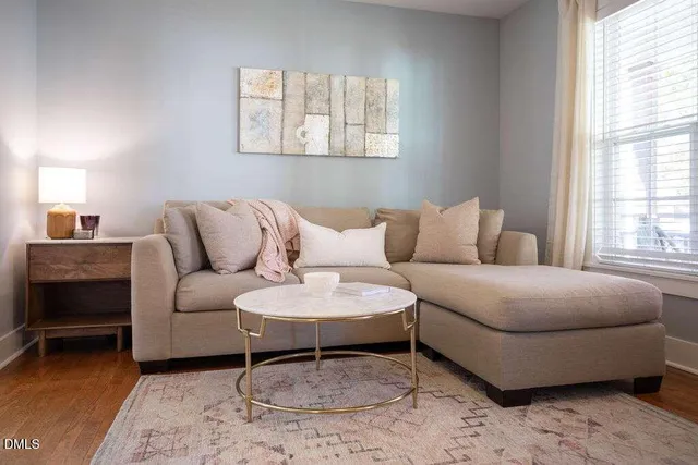 a view of a dining room with furniture and chandelier