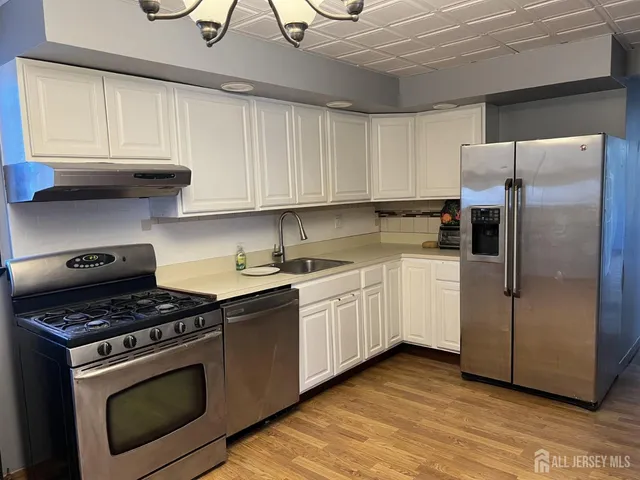a kitchen with cabinets and steel stainless steel appliances