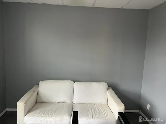 a bathroom with a toilet a sink a mirror and a window