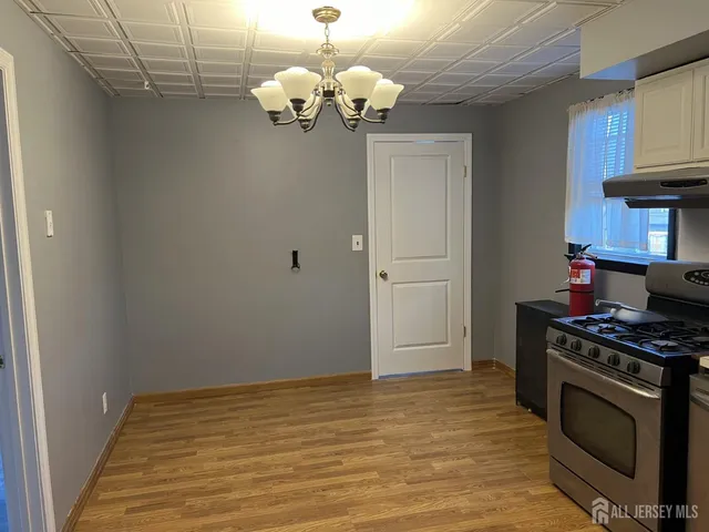 a kitchen with stainless steel appliances granite countertop a stove a refrigerator and a sink