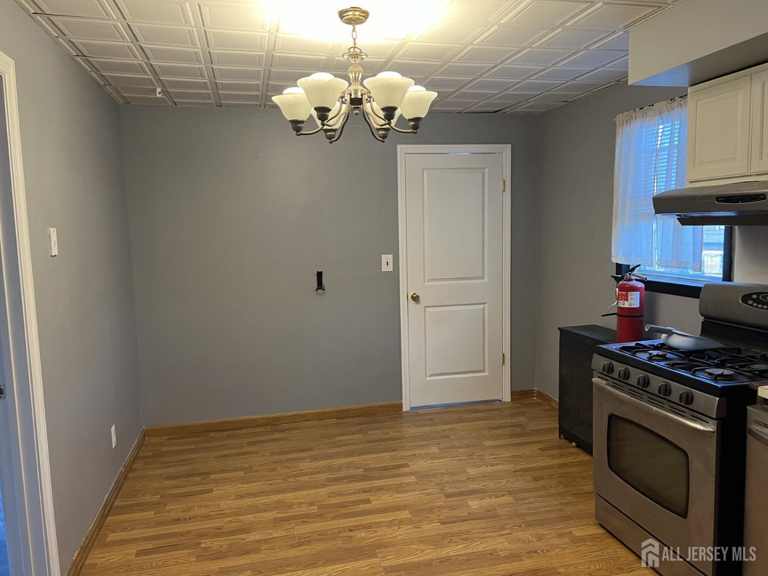 247 Washington Avenue, Unit 2F Carteret, NJ 07008 - Photo 6 of 10 a kitchen with stainless steel appliances granite countertop a stove a refrigerator and a stove