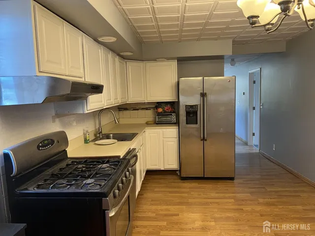 a view of a room with wooden floor