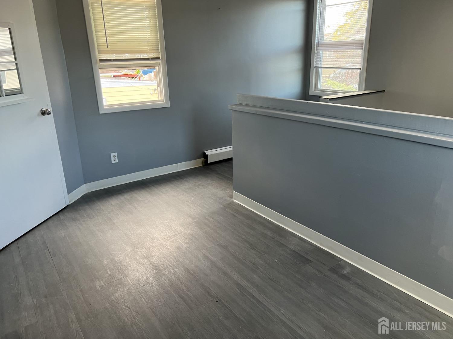 247 Washington Avenue, Unit 2F Carteret, NJ 07008 - Photo 9 of 10 an empty room with wooden floor and windows