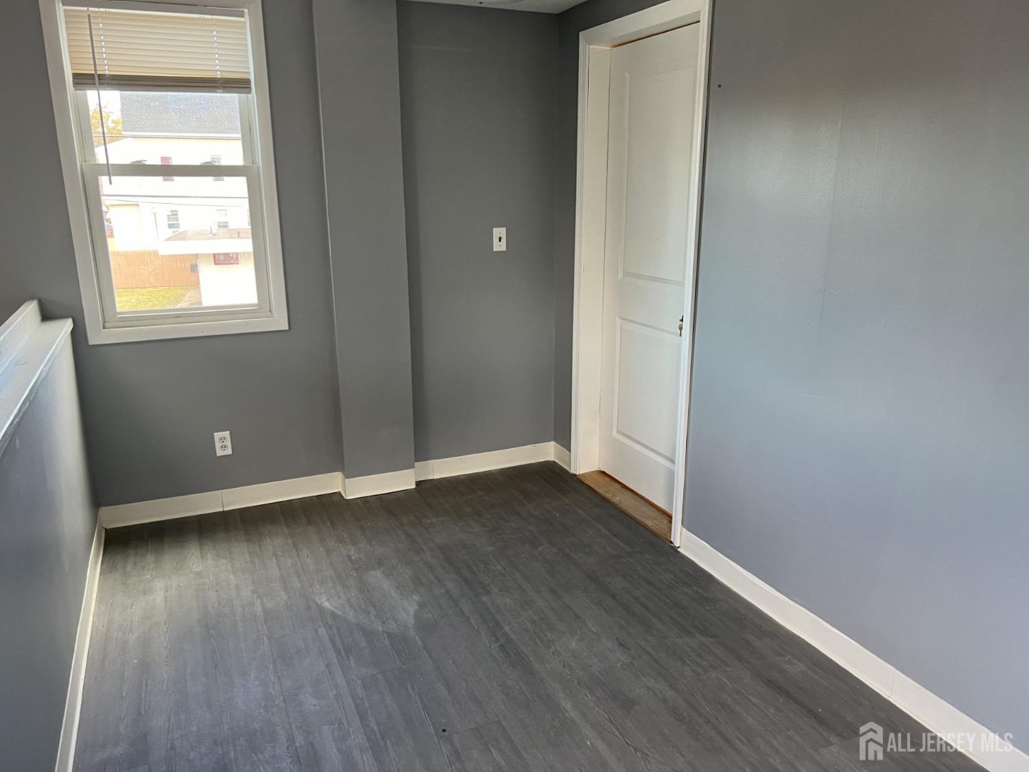 247 Washington Avenue, Unit 2F Carteret, NJ 07008 - Photo 10 of 10 an empty room with wooden floor and windows