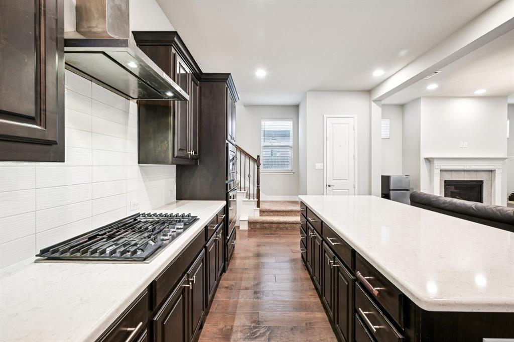 8039 Copper Way Dallas, TX 75252 - Photo 11 of 30 a kitchen with a stove and a sink