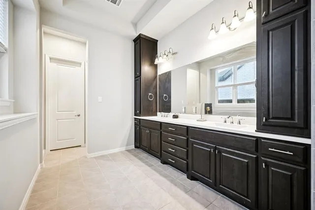 a spacious bathroom with a shower sink mirror and