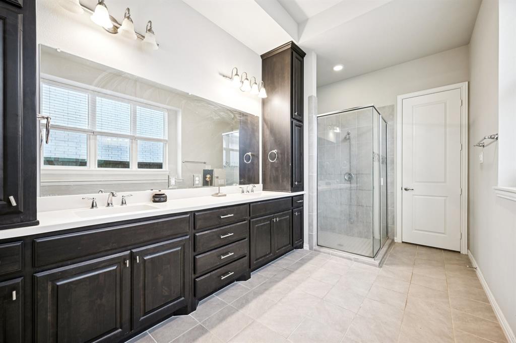 8039 Copper Way Dallas, TX 75252 - Photo 18 of 30 a spacious bathroom with a shower sink mirror and