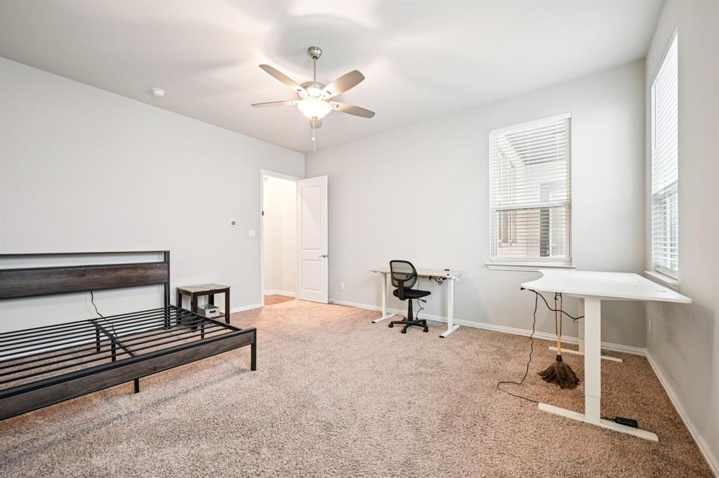 8039 Copper Way Dallas, TX 75252 - Photo 21 of 30 a bedroom with furniture and a window