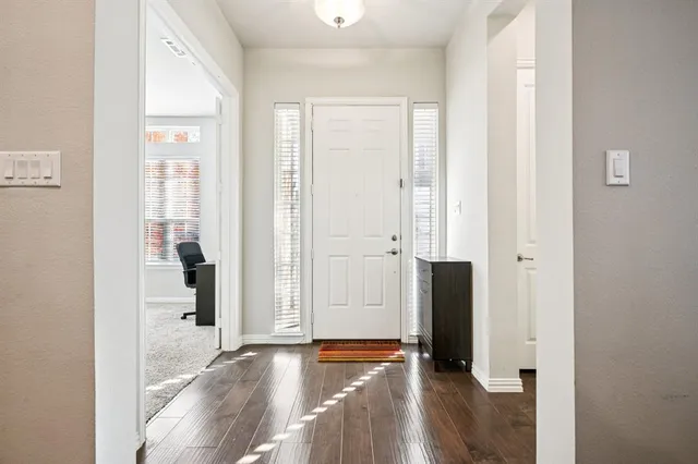wooden floor with view in front door