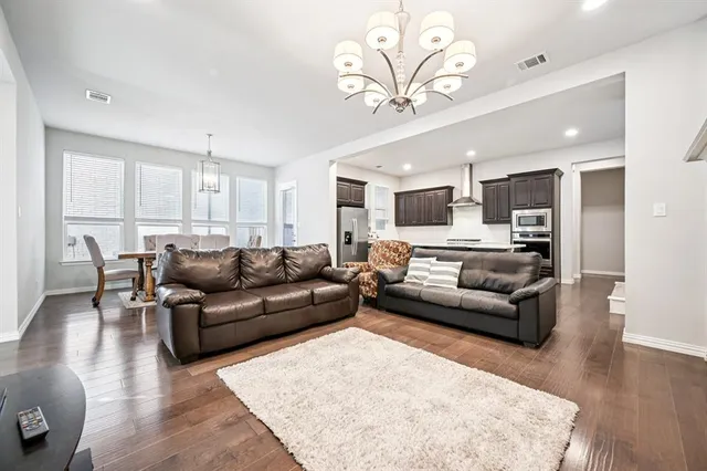 a living room with furniture or kitchen view and a wooden floor