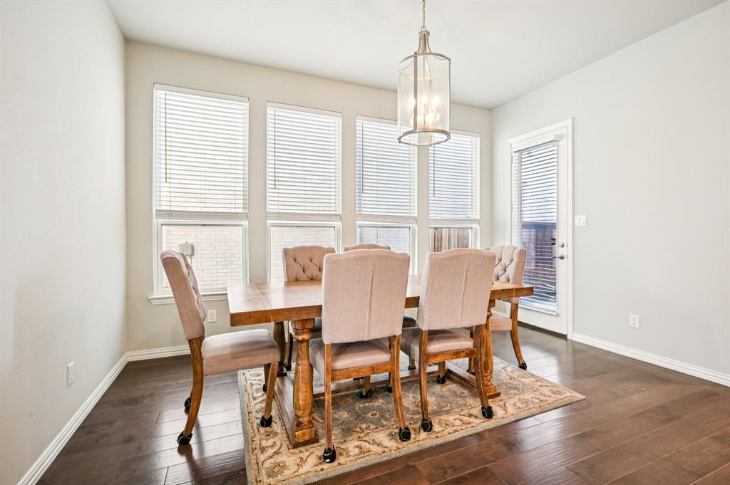 8039 Copper Way Dallas, TX 75252 - Photo 8 of 30 a view of a dining room with furniture window and wooden floor