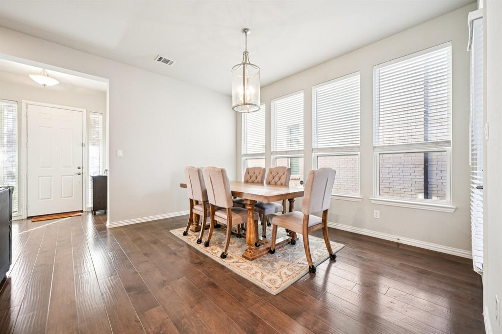 8039 Copper Way Dallas, TX 75252 - Photo 9 of 30 a dining room with furniture and wooden floor