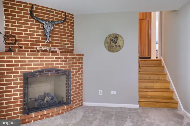 a view of a fireplace with a hallway