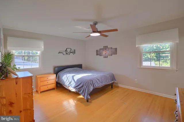 a spacious bedroom with a bed and a window