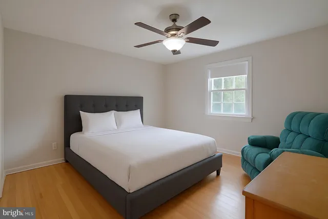 a bedroom with a bed couch and window