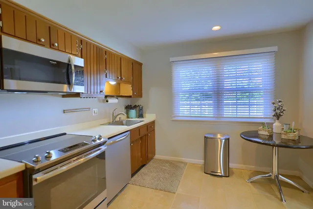 a kitchen with stainless steel appliances granite countertop a sink and a microwave