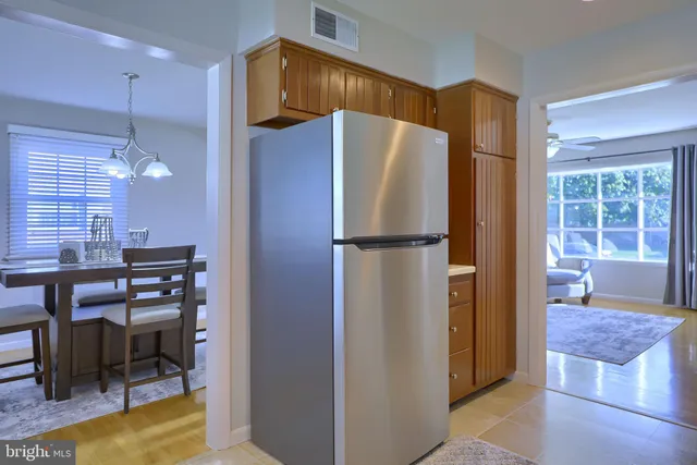 a kitchen with stainless steel appliances granite countertop a refrigerator and a table