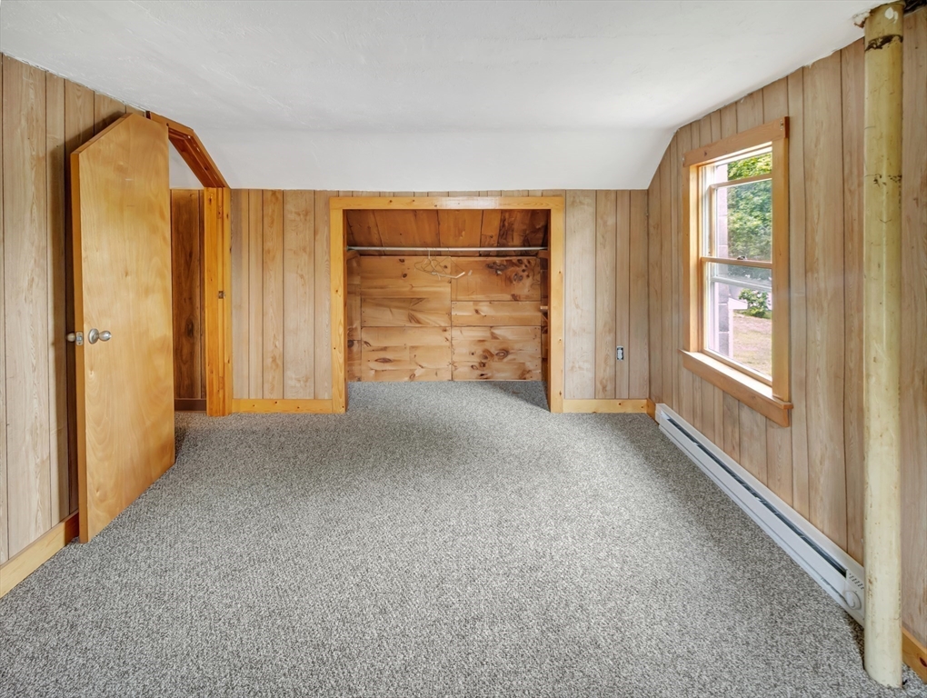 10 Ridge Road Norton, MA 02766 - Photo 28 of 34 a view of an empty room with a fireplace and a window