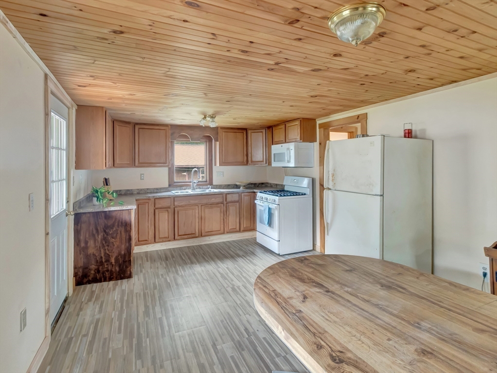 10 Ridge Road Norton, MA 02766 - Photo 7 of 34 a kitchen with wooden floors and refrigerator