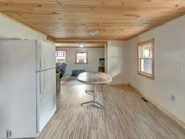 a view of a room with wooden floor and a window