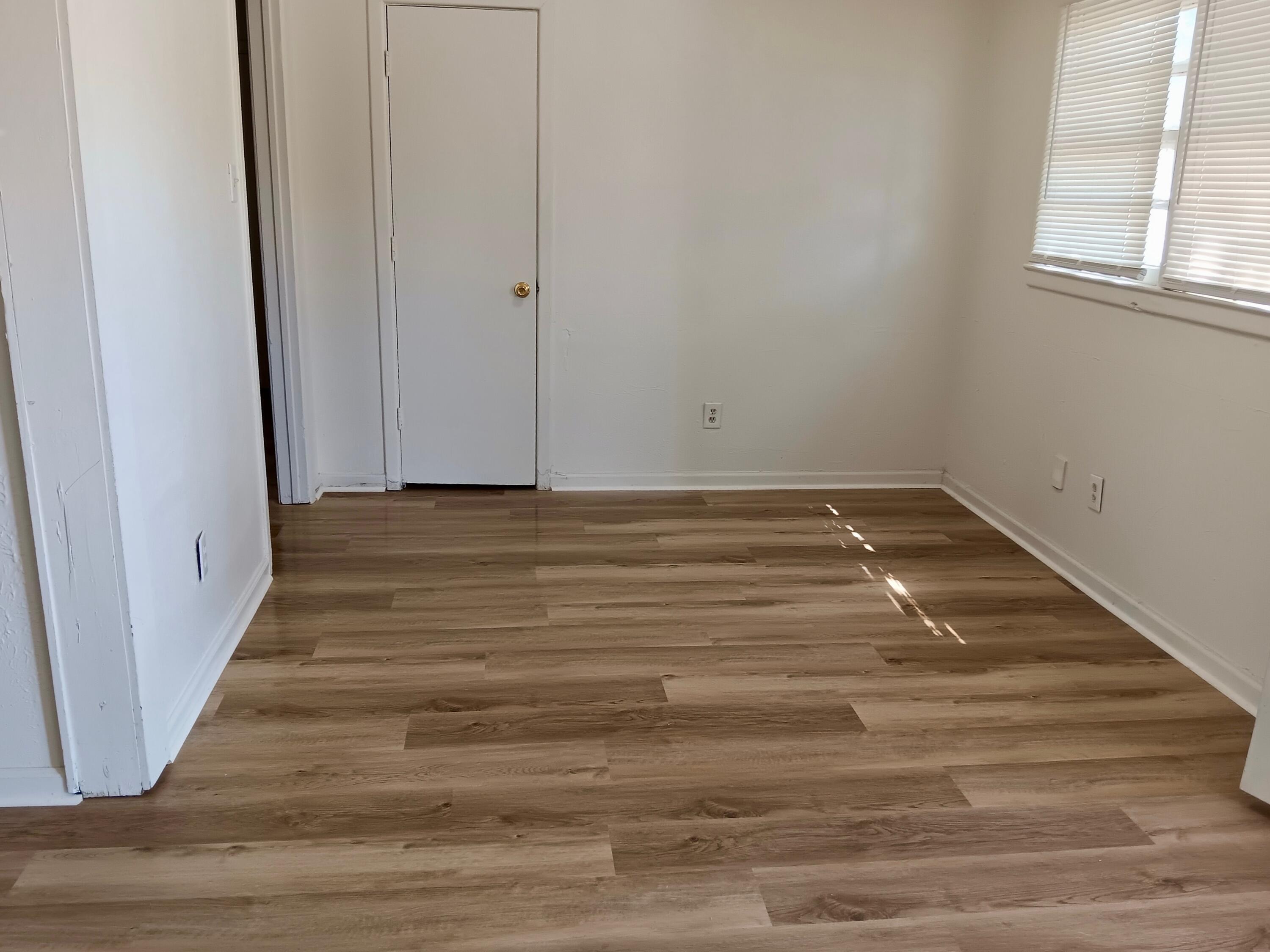 Turn-key St Lubbock Tx 79403 Lubbock, TX 79411 - Photo 11 of 18 a view of a room with wooden floor and white walls