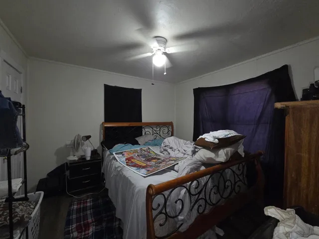 a bedroom with bed and a tv