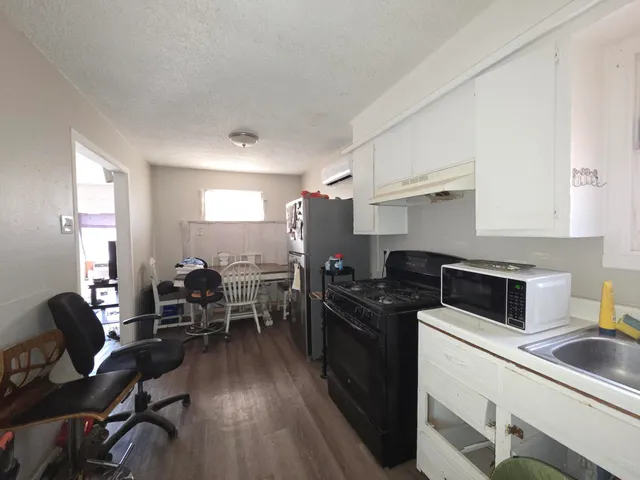 a kitchen with sink wooden cabinets and stainless steel appliances