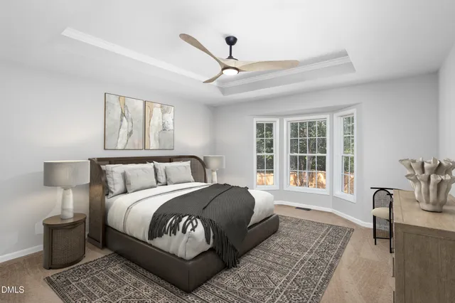 an empty room with ceiling fan and windows